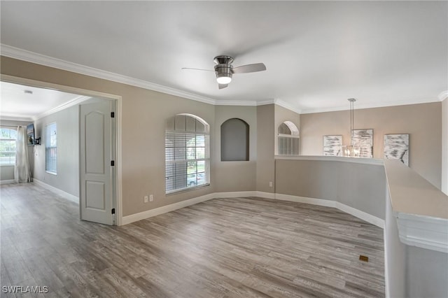 4582 Fairloop Run, Lehigh Acres, FL 33973 - empty room featuring a chandelier, wood finished floors, ornamental molding, and a ceiling fan