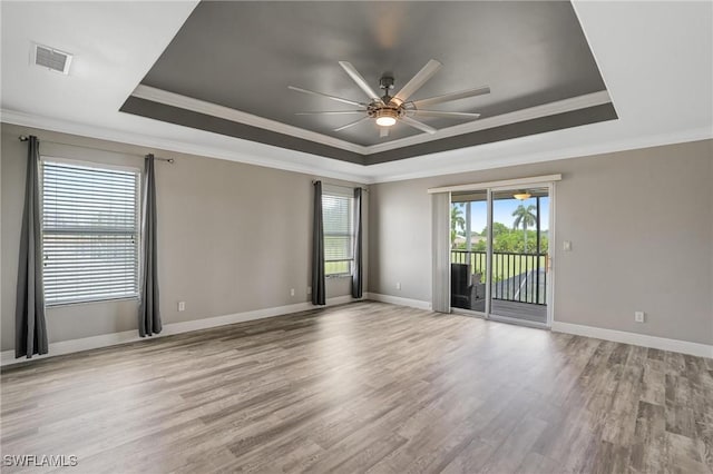 4582 Fairloop Run, Lehigh Acres, FL 33973 - spare room featuring a tray ceiling, crown molding, a ceiling fan, and light wood finished floors