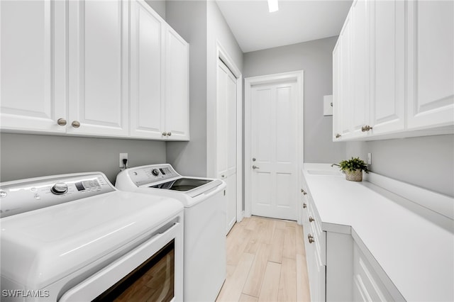 3262 Sedge Pl, Naples, FL 34105 - laundry area featuring washer and clothes dryer, cabinet space, and light wood finished floors