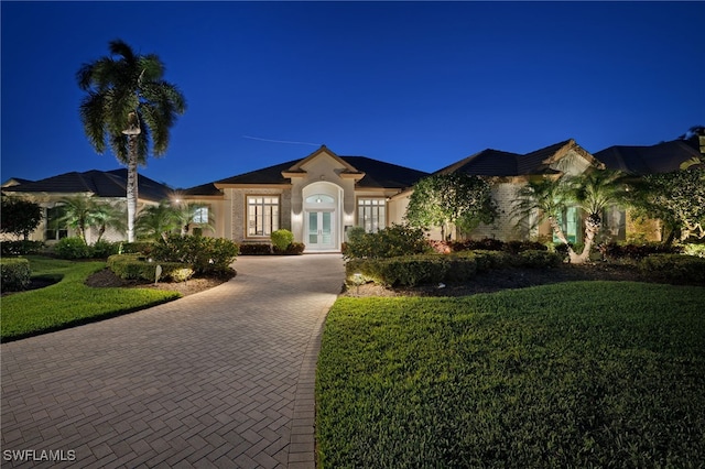3262 Sedge Pl, Naples, FL 34105 - mediterranean / spanish home featuring french doors, a lawn, decorative driveway, and stucco siding