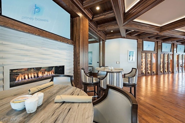 3262 Sedge Pl, Naples, FL 34105 - dining space featuring a multi sided fireplace, coffered ceiling, beamed ceiling, ornamental molding, and wood finished floors