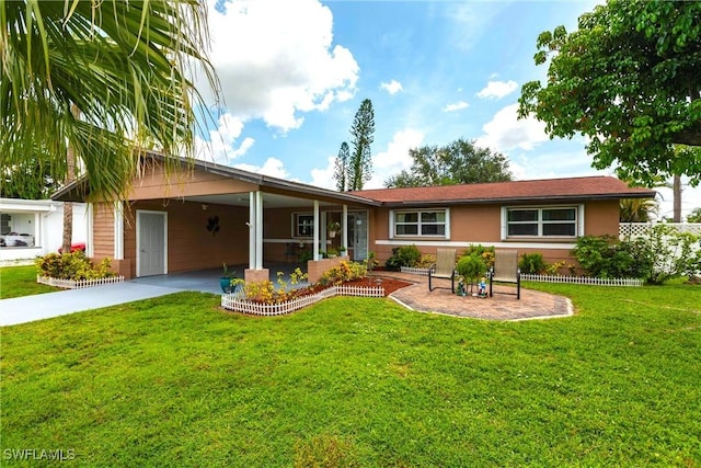 401 NE 14th Pl, Cape Coral, FL 33909 - view of front of house featuring a carport, a front lawn, driveway, and stucco siding