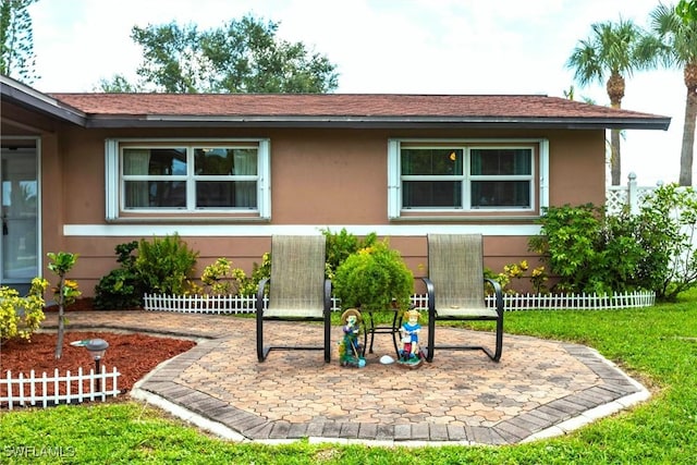 401 NE 14th Pl, Cape Coral, FL 33909 - view of front of home with stucco siding and a patio