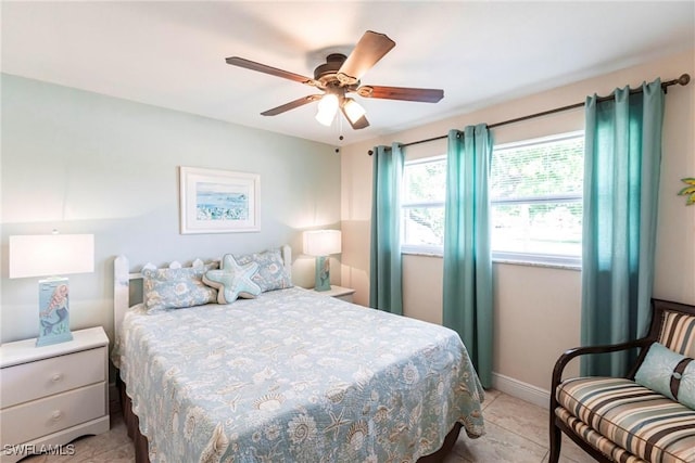401 NE 14th Pl, Cape Coral, FL 33909 - bedroom with light tile patterned flooring and a ceiling fan