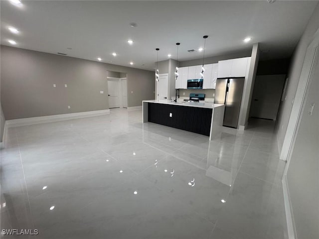 714 Euston Ave S, Lehigh Acres, FL 33974 - kitchen with stainless steel appliances, an island with sink, white cabinetry, light countertops, and recessed lighting