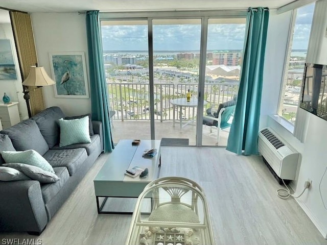 7330 Estero Blvd Unit 1107, Fort Myers Beach, FL 33931 - living room with wood finished floors, a wall mounted air conditioner, and a view of city