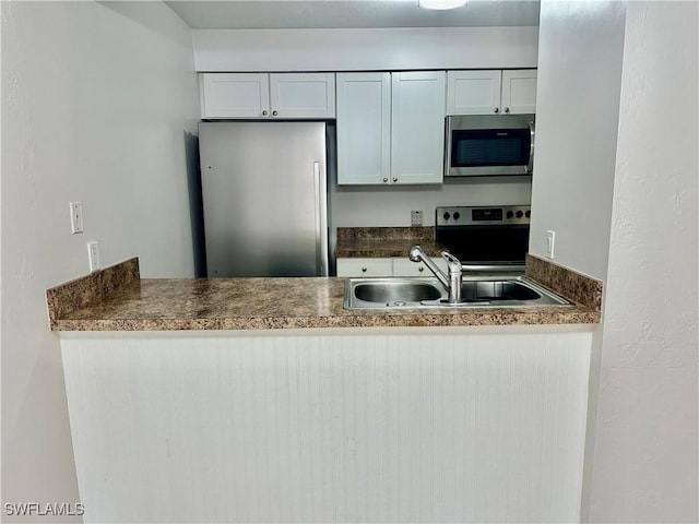 13118 Feather Sound Dr Unit 208, Fort Myers, FL 33919 - kitchen with appliances with stainless steel finishes and a peninsula