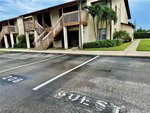 13118 Feather Sound Dr Unit 208, Fort Myers, FL 33919 - view of property with uncovered parking and stairway