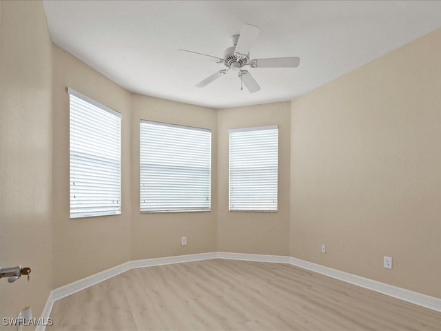 6491 Marbella Dr, Naples, FL 34105 - empty room with light wood finished floors, plenty of natural light, and a ceiling fan