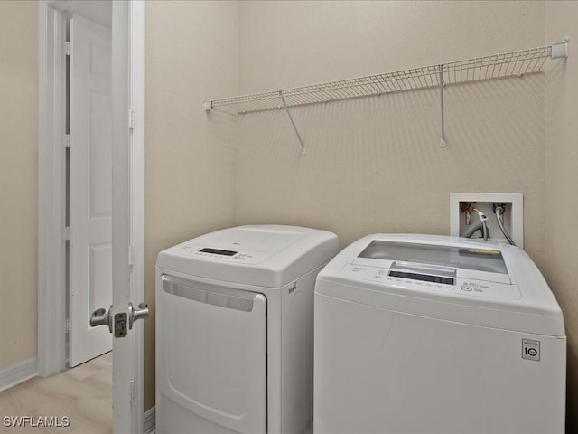 6491 Marbella Dr, Naples, FL 34105 - washroom featuring separate washer and dryer and baseboards