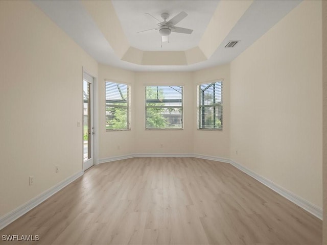 6491 Marbella Dr, Naples, FL 34105 - spare room featuring light wood-type flooring, ceiling fan, and a tray ceiling