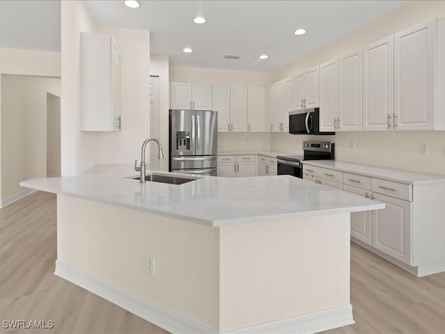 6491 Marbella Dr, Naples, FL 34105 - kitchen with appliances with stainless steel finishes, a peninsula, light wood-style floors, and recessed lighting