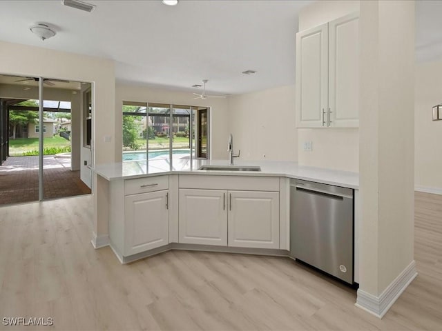 6491 Marbella Dr, Naples, FL 34105 - kitchen with stainless steel dishwasher, ceiling fan, a peninsula, light countertops, and white cabinetry