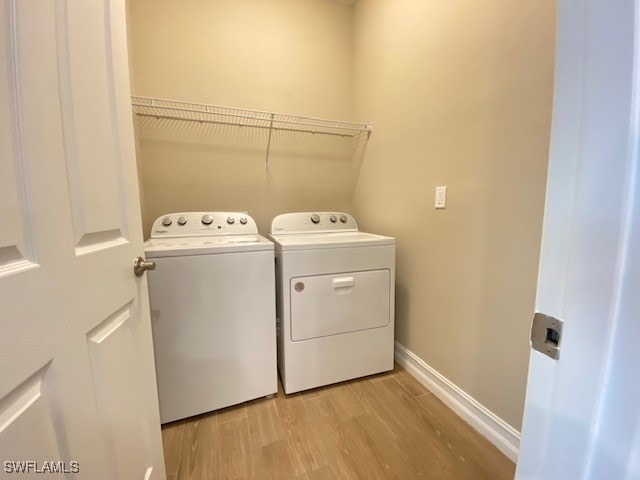 1023 Enbrook Loop, Naples, FL 34114 - laundry room with washer and clothes dryer and light wood-style flooring