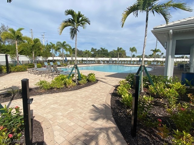 1023 Enbrook Loop, Naples, FL 34114 - community pool with a patio area
