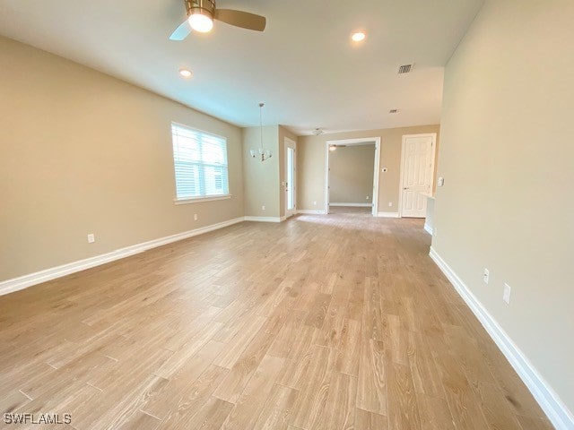 1023 Enbrook Loop, Naples, FL 34114 - unfurnished room with light wood-type flooring, a ceiling fan, a chandelier, and recessed lighting