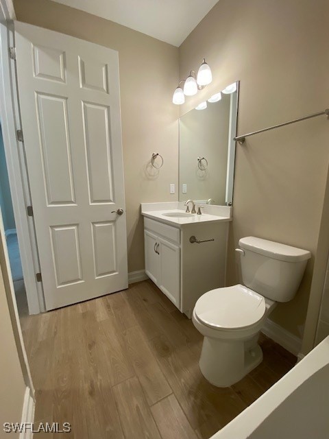 1023 Enbrook Loop, Naples, FL 34114 - bathroom with vanity and wood finished floors