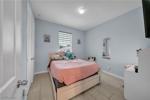 1421 SW 13th Ter, Cape Coral, FL 33991 - bedroom with light tile patterned flooring and baseboards