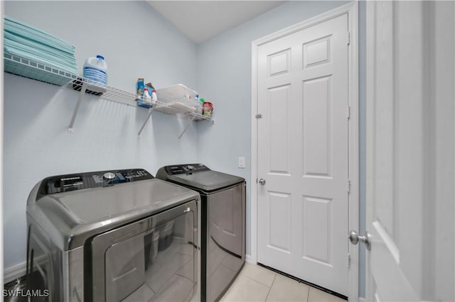 1421 SW 13th Ter, Cape Coral, FL 33991 - laundry area featuring washer and clothes dryer and light tile patterned floors