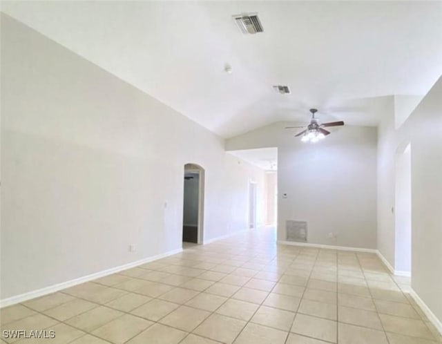 4839 18th St NE Unit 1, Naples, FL 34120 - empty room with arched walkways, a ceiling fan, light tile patterned flooring, and vaulted ceiling