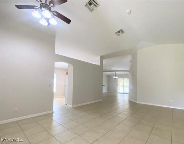4839 18th St NE Unit 1, Naples, FL 34120 - unfurnished room featuring arched walkways, a ceiling fan, light tile patterned floors, and lofted ceiling