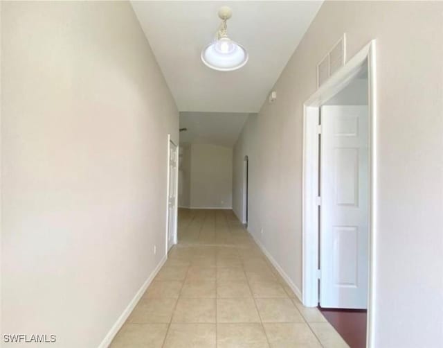 4839 18th St NE Unit 1, Naples, FL 34120 - hallway featuring light tile patterned flooring and baseboards