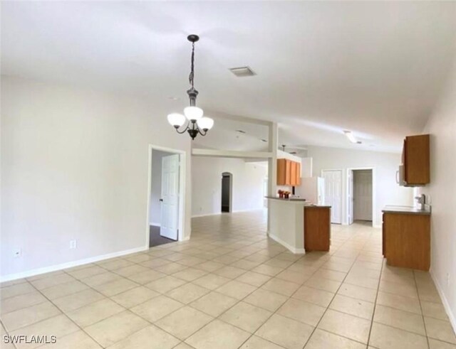 4839 18th St NE Unit 1, Naples, FL 34120 - kitchen featuring open floor plan, a chandelier, light tile patterned floors, pendant lighting, and fridge