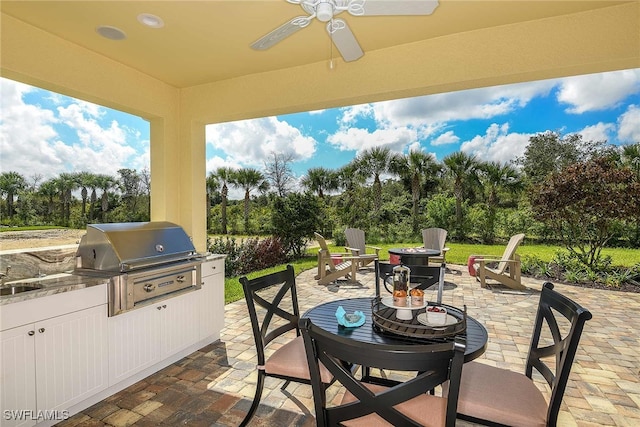 4088 Pegasus Way, Naples, FL 34120 - view of patio / terrace featuring an outdoor fire pit, area for grilling, view of wooded area, and a ceiling fan