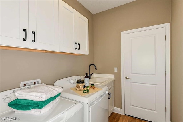 4563 Centaurus Cir, Naples, FL 34120 - laundry area featuring cabinet space, washer and dryer, and wood finished floors
