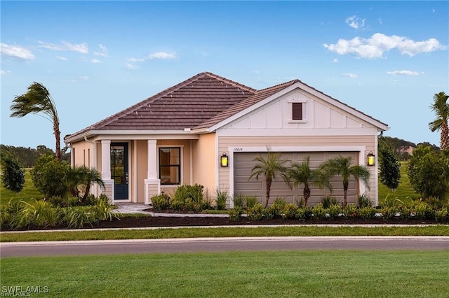 4563 Centaurus Cir, Naples, FL 34120 - view of front facade with a front yard, a garage, and board and batten siding