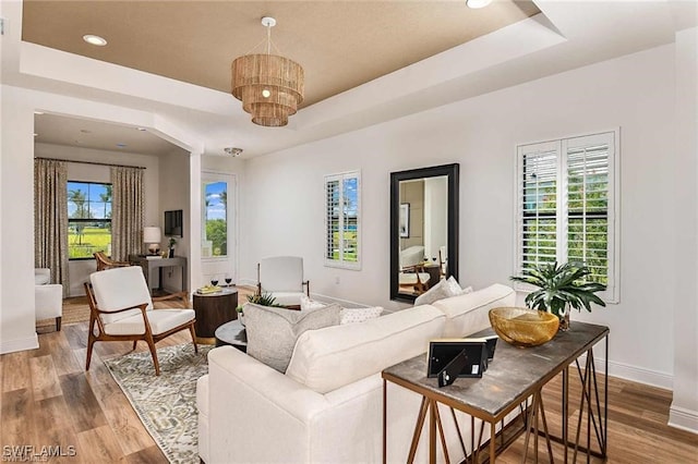 4563 Centaurus Cir, Naples, FL 34120 - living area with a tray ceiling, wood finished floors, a chandelier, and recessed lighting