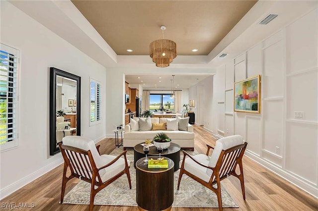 4563 Centaurus Cir, Naples, FL 34120 - living room featuring light wood finished floors, a raised ceiling, and recessed lighting