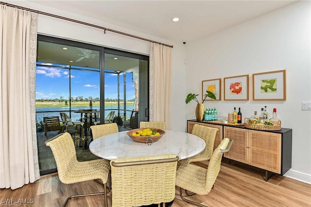 4563 Centaurus Cir, Naples, FL 34120 - dining space with light wood-style floors, a water view, and recessed lighting
