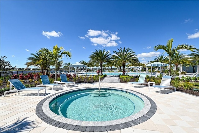 4577 Centaurus Cir, Naples, FL 34120 - community pool featuring a patio