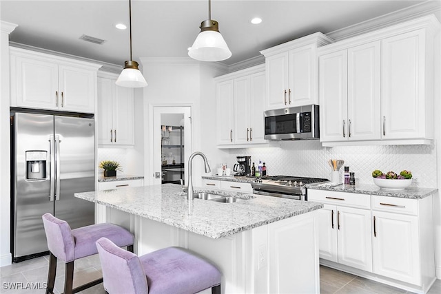 4577 Centaurus Cir, Naples, FL 34120 - kitchen with stainless steel appliances, decorative backsplash, a kitchen island with sink, a breakfast bar area, and light stone countertops