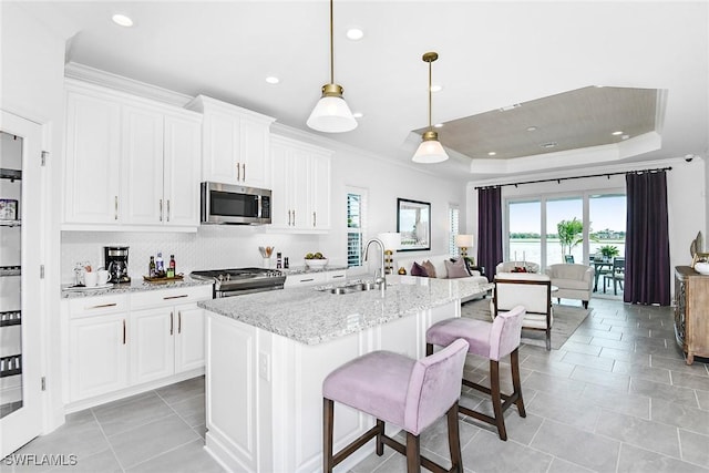 4577 Centaurus Cir, Naples, FL 34120 - kitchen featuring stainless steel appliances, plenty of natural light, tasteful backsplash, recessed lighting, and light stone countertops