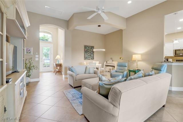 14642 Speranza Way, Bonita Springs, FL 34135 - living room featuring arched walkways, a ceiling fan, and light tile patterned floors