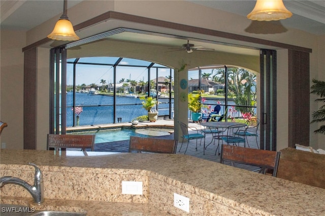 3606 Whippoorwill Blvd, Punta Gorda, FL 33950 - kitchen with ceiling fan, a water view, and decorative light fixtures