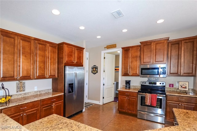 3606 Whippoorwill Blvd, Punta Gorda, FL 33950 - kitchen featuring appliances with stainless steel finishes, recessed lighting, light stone counters, and dark tile patterned floors