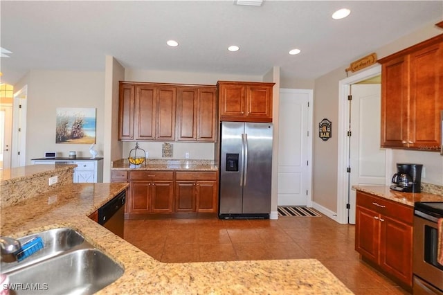 3606 Whippoorwill Blvd, Punta Gorda, FL 33950 - kitchen with appliances with stainless steel finishes, tile patterned floors, light stone countertops, recessed lighting, and brown cabinetry
