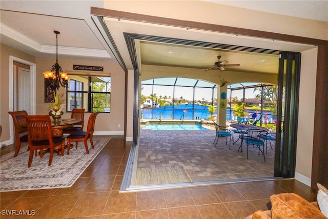3606 Whippoorwill Blvd, Punta Gorda, FL 33950 - tiled dining room featuring a chandelier, ceiling fan, crown molding, and a tray ceiling