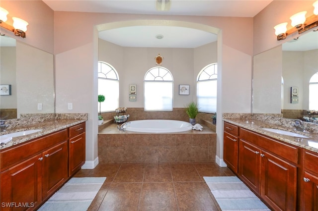 3606 Whippoorwill Blvd, Punta Gorda, FL 33950 - bathroom with plenty of natural light, a garden tub, and two vanities