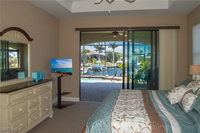 3606 Whippoorwill Blvd, Punta Gorda, FL 33950 - carpeted bedroom featuring access to outside, a tray ceiling, a water view, multiple windows, and crown molding