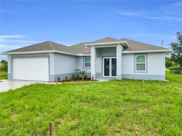 2718 42nd St W, Lehigh Acres, FL 33971 - view of front of home featuring french doors, stucco siding, a garage, a front lawn, and driveway