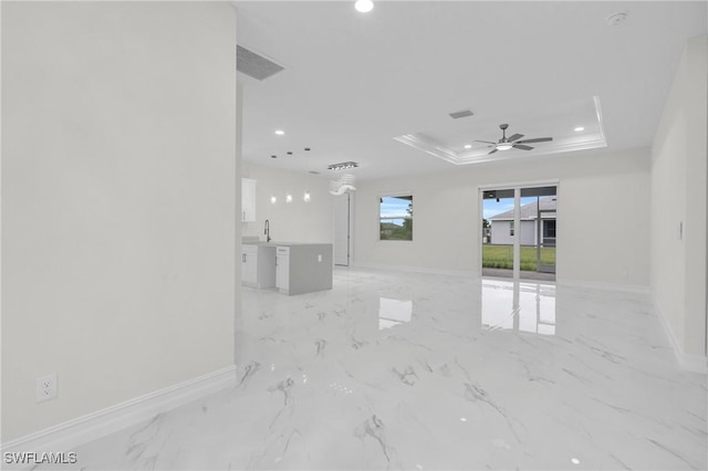 2718 42nd St W, Lehigh Acres, FL 33971 - unfurnished living room featuring a tray ceiling, recessed lighting, ceiling fan, and light marble finish flooring