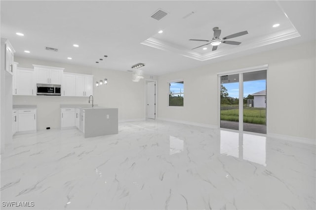 2718 42nd St W, Lehigh Acres, FL 33971 - unfurnished living room with a tray ceiling, ceiling fan, recessed lighting, ornamental molding, and light marble finish flooring