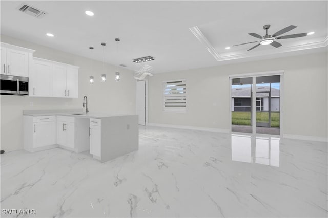2718 42nd St W, Lehigh Acres, FL 33971 - kitchen featuring stainless steel microwave, open floor plan, recessed lighting, a ceiling fan, and white cabinetry