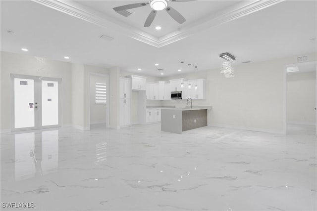 2718 42nd St W, Lehigh Acres, FL 33971 - unfurnished living room with a tray ceiling, light marble finish flooring, a ceiling fan, crown molding, and recessed lighting