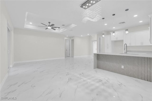 2718 42nd St W, Lehigh Acres, FL 33971 - unfurnished living room with light marble finish flooring, recessed lighting, ceiling fan, and a raised ceiling