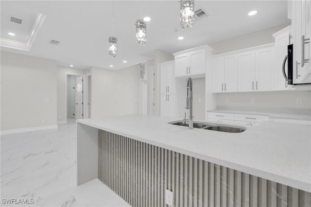2718 42nd St W, Lehigh Acres, FL 33971 - kitchen featuring light marble finish flooring, recessed lighting, white cabinetry, decorative light fixtures, and stainless steel microwave